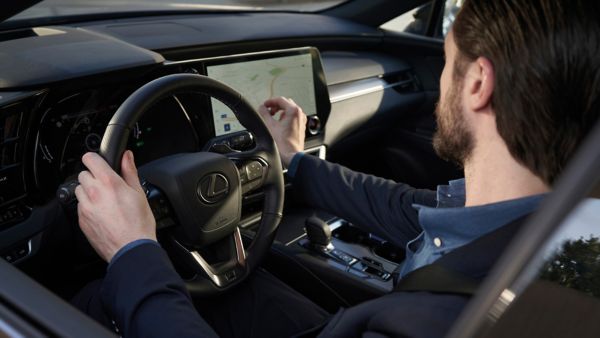 A person driving a Lexus