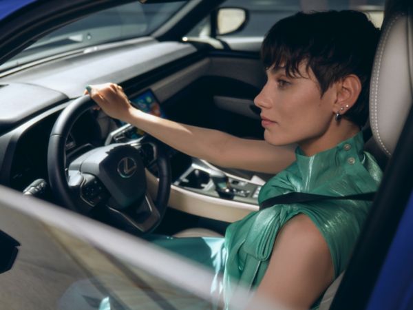 A driver with their hands on a Lexus steering wheel