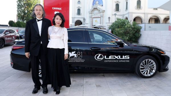 acob Wong and Zhang Xiaowen stood by a Lexus at the 81st Venice film festival