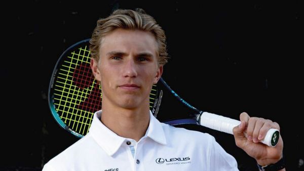 A tennis player in the white Lexus polo holding a racket