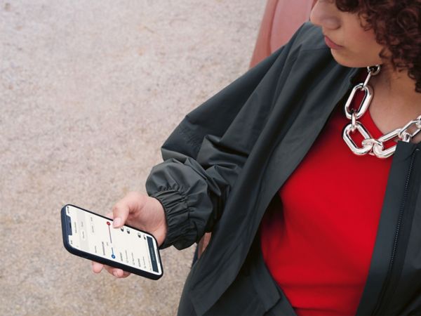 A person using a mobile phone to access the Lexus Link app