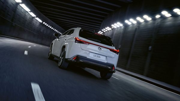 A white Lexus driving in a tunnel