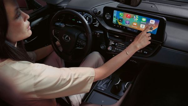 A woman using a Lexus touchscreen