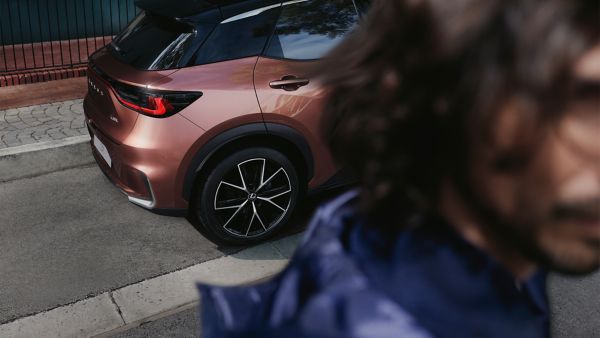 Lexus RZ plugged into a charging tower