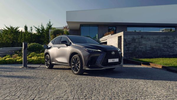 A Lexus NX charging outside a property