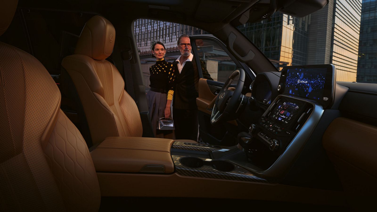 Two people stood in the doorway of a Lexus LX