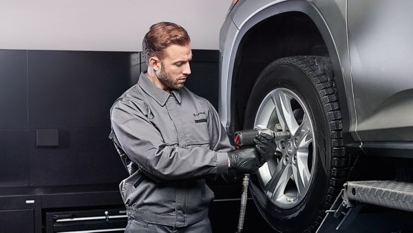 A Lexus mechanic working on a Lexus wheel