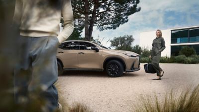 Lexus LX driving around a corner in a city location 