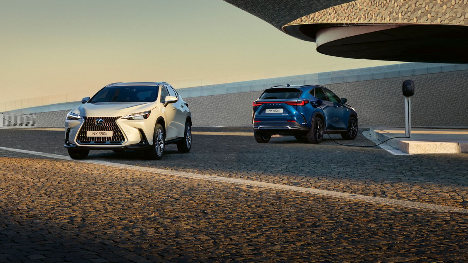 Parked Lexus NX 350h and NX 450h+ plugged into charging point