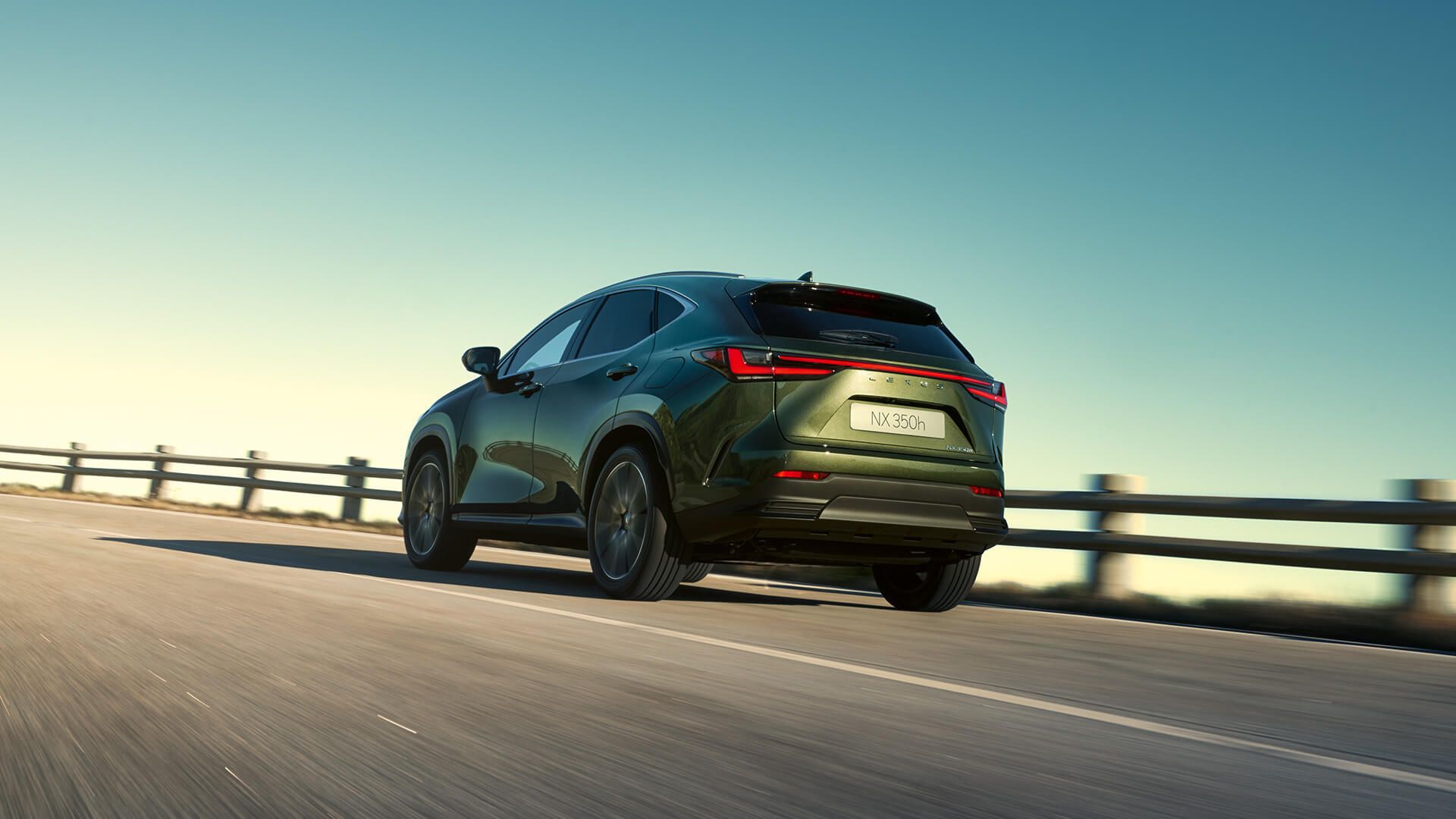 Rear view of a Lexus NX 350h driving on a road