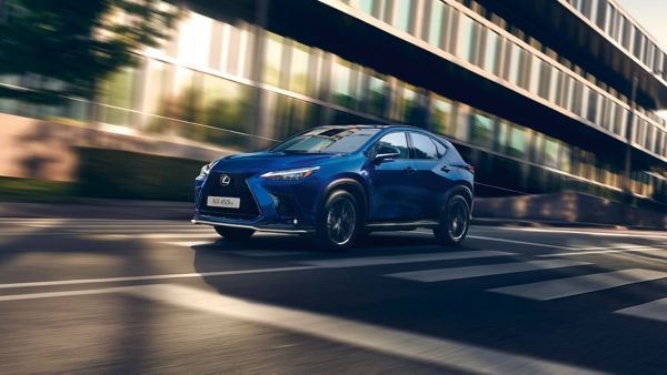 Lexus NX driving through a street