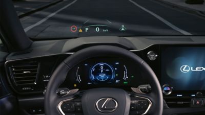 Lexus LX driving around a corner in a city location 