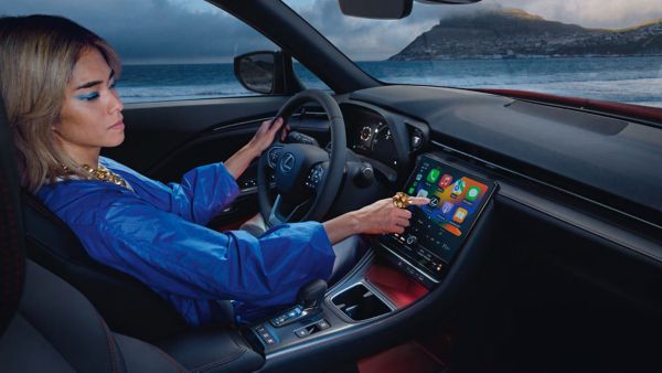 Alt text - A person interacting with a Lexus multimedia touchscreen