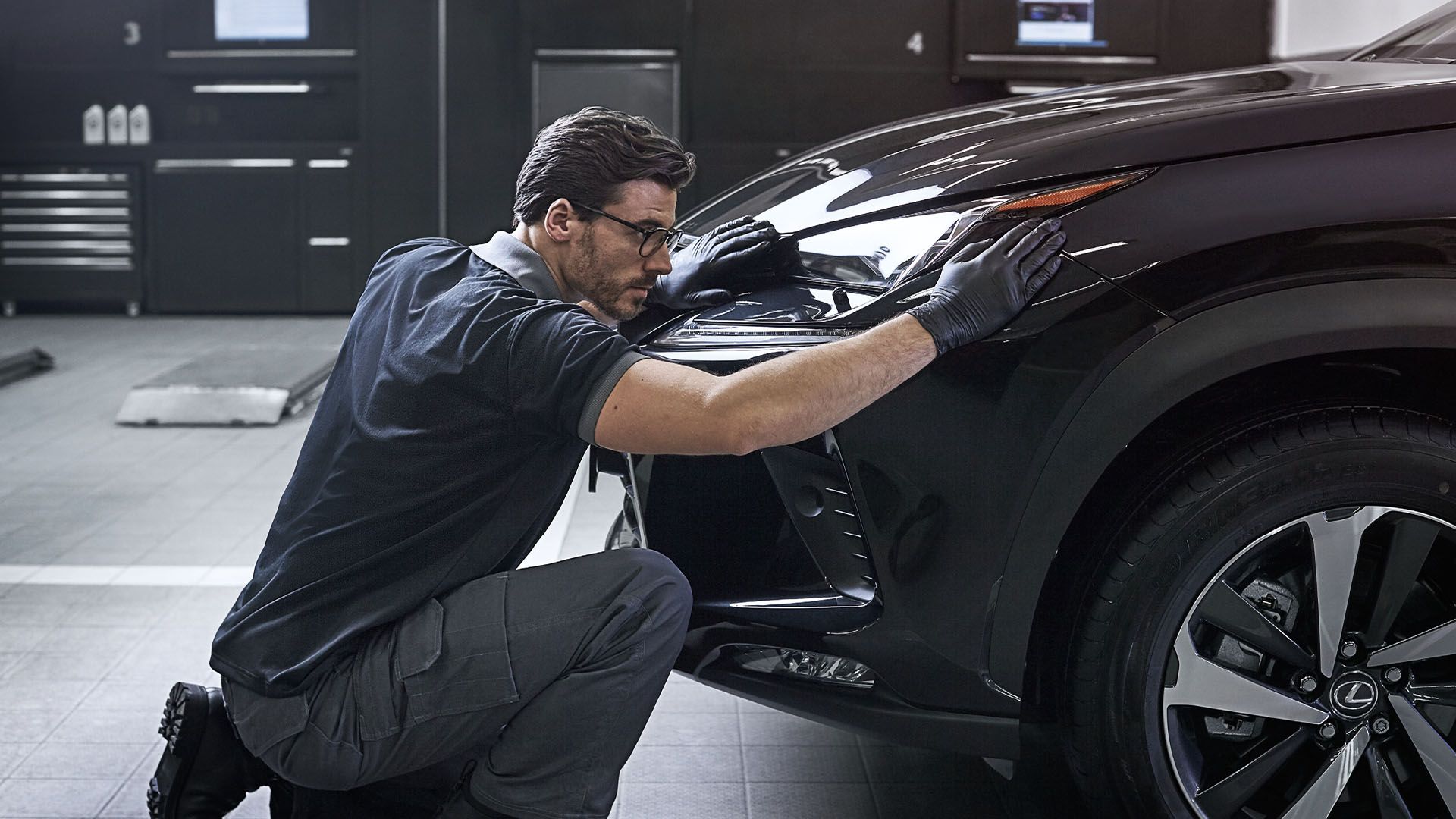 Lexus service tecnician inspecting car 