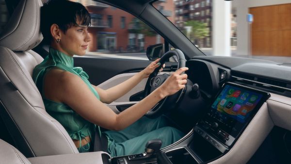 A woman driving a Lexus NX