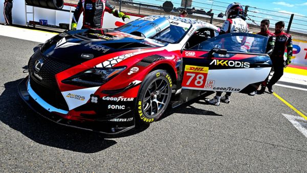 A driver and mechanics surrounding a parked Lexus RC F GT3