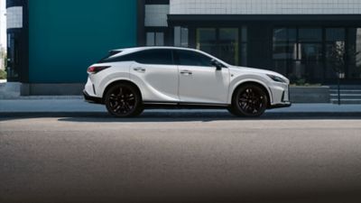 Lexus LX driving around a corner in a city location 