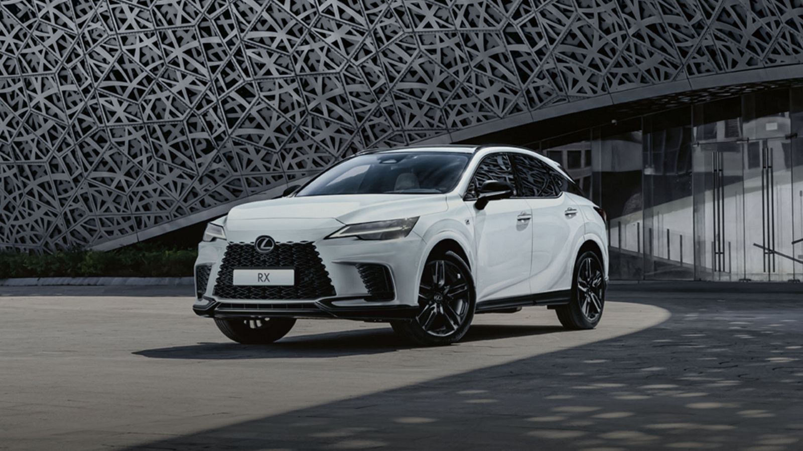 Front view of a Lexus RX 500h driving on a road