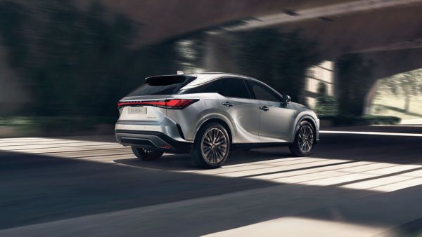 A Lexus RX driving under a bridge