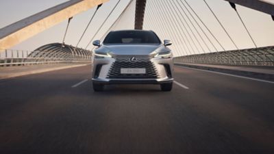 Lexus LX driving around a corner in a city location 