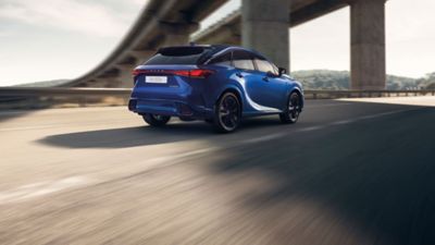 Lexus LX driving around a corner in a city location 