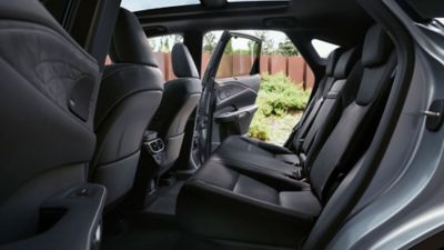 Lexus LX driving around a corner in a city location 