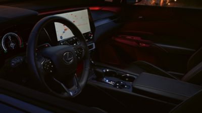 Lexus LX driving around a corner in a city location 