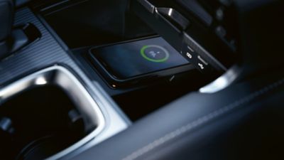 Lexus LX driving around a corner in a city location 