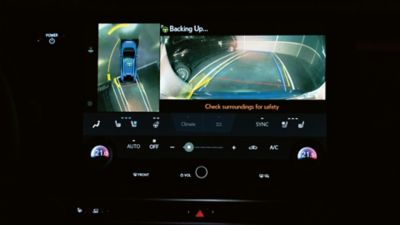 Lexus LX driving around a corner in a city location 