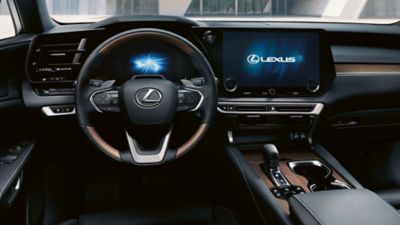 Lexus LX driving around a corner in a city location 