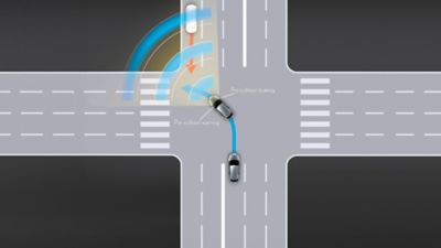 Lexus LX driving around a corner in a city location 