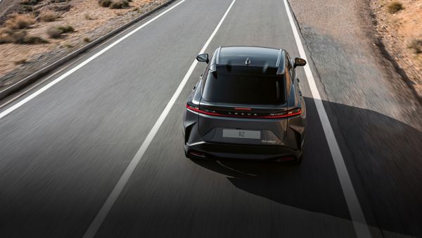 A Lexus RZ 450e plugged into a charging tower