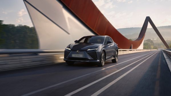 Lexus RZ driving through a wind farm