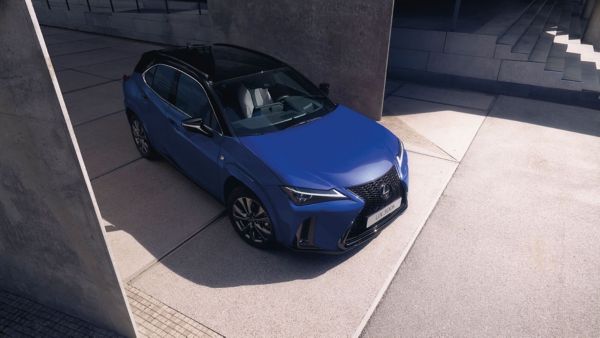 Ein blauer Lexus UX 300h, geparkt auf einer modernen Betonfläche