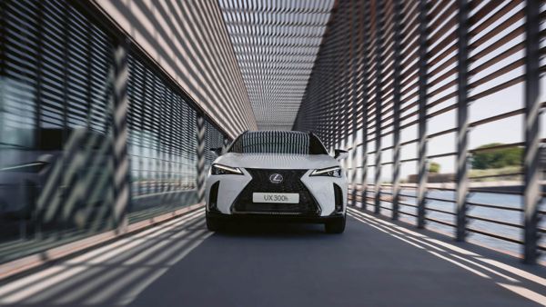 A Lexus UX driving down a city street