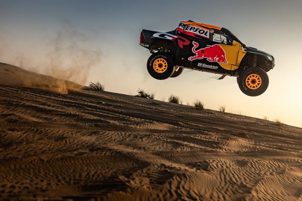 A Toyota GR DKR Hilux Evo flies through the air