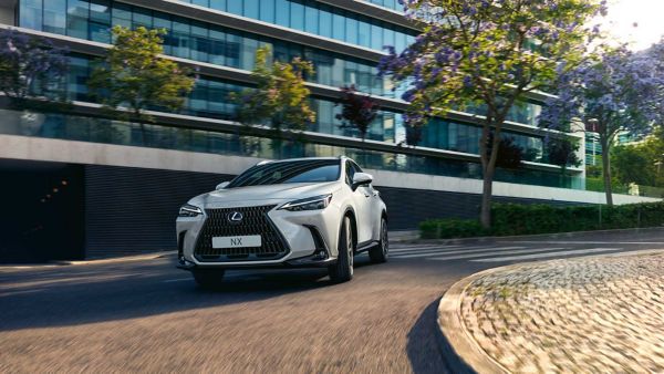 A Lexus NX driving through a corner in the road