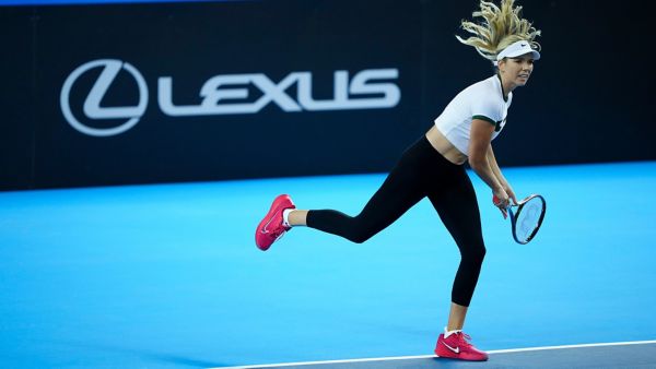 Katie Boulter playing tennis with the Lexus logo in the background