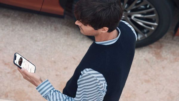 A person using a mobile phone to access the Lexus Link+ app