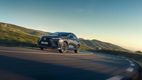 A Lexus NX driving on a hillside road