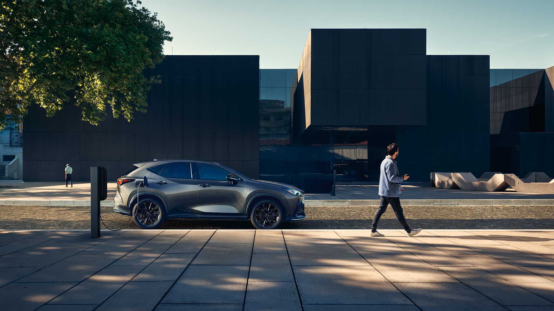 A parked Lexus NX charging on a street