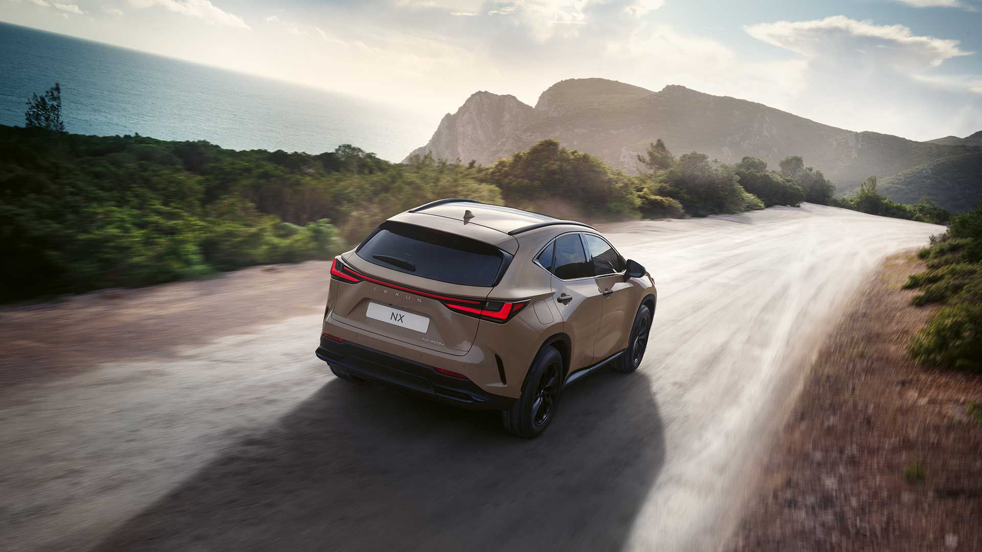 Rear view of a Lexus NX driving on a coastal road