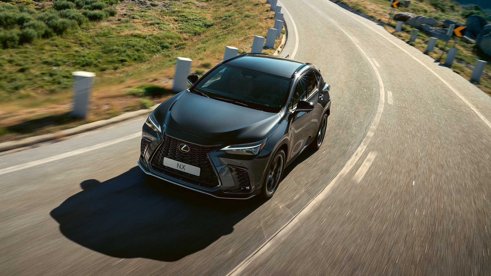 Front view of a Lexus NX driving on a rural road