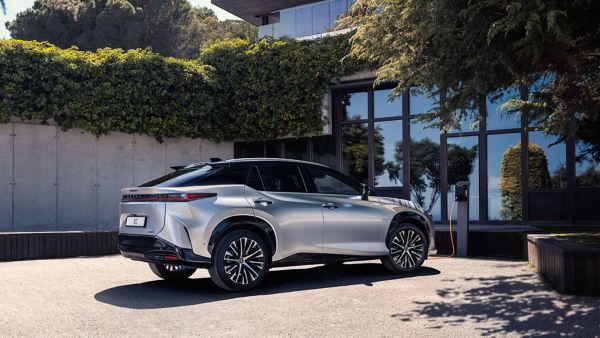 A Lexus RZ parked outside a house