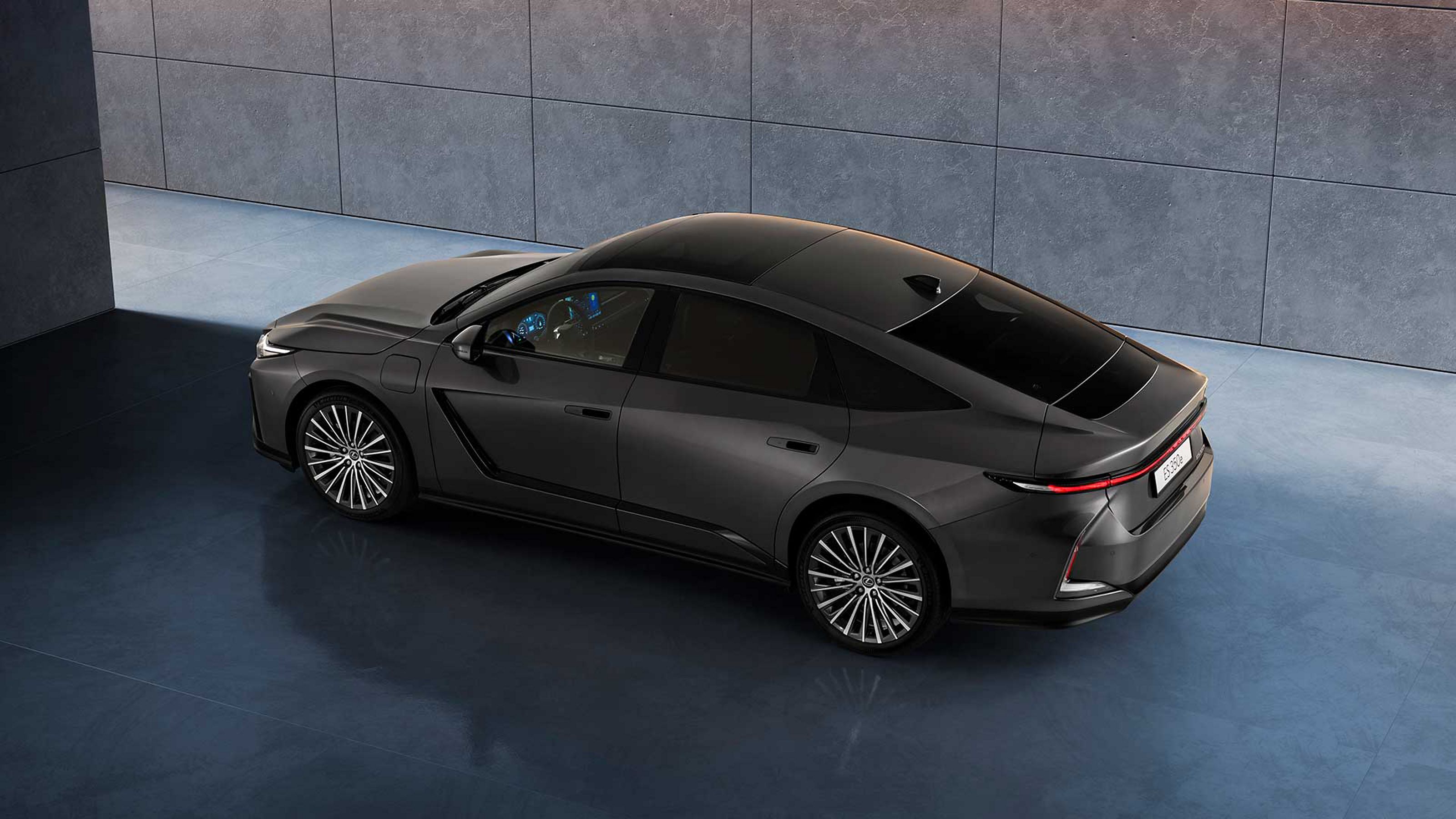 Raised rear three-quarter angle of a parked all-new Lexus ES