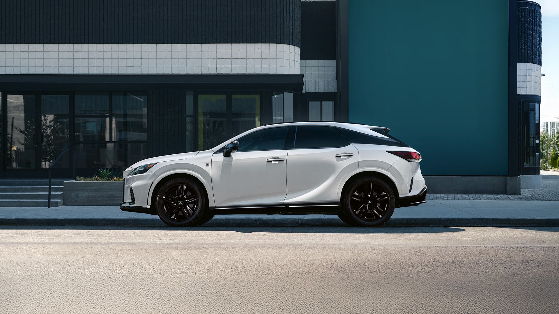 Rear view of a Lexus RX driving on a coastal road