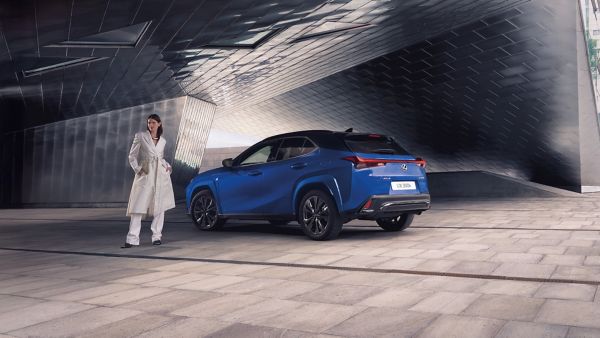 A person stood next to a parked Lexus UX 300h