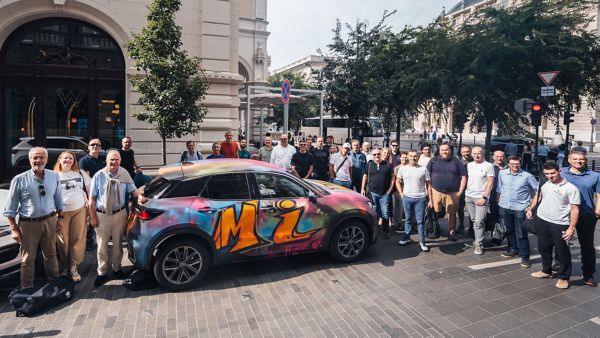 Personas de pie junto al coche con grafiti de Lexus