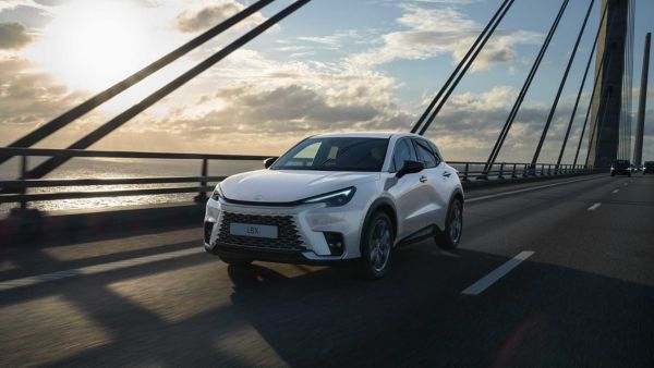 A Lexus LBX driving across a suspension bridge