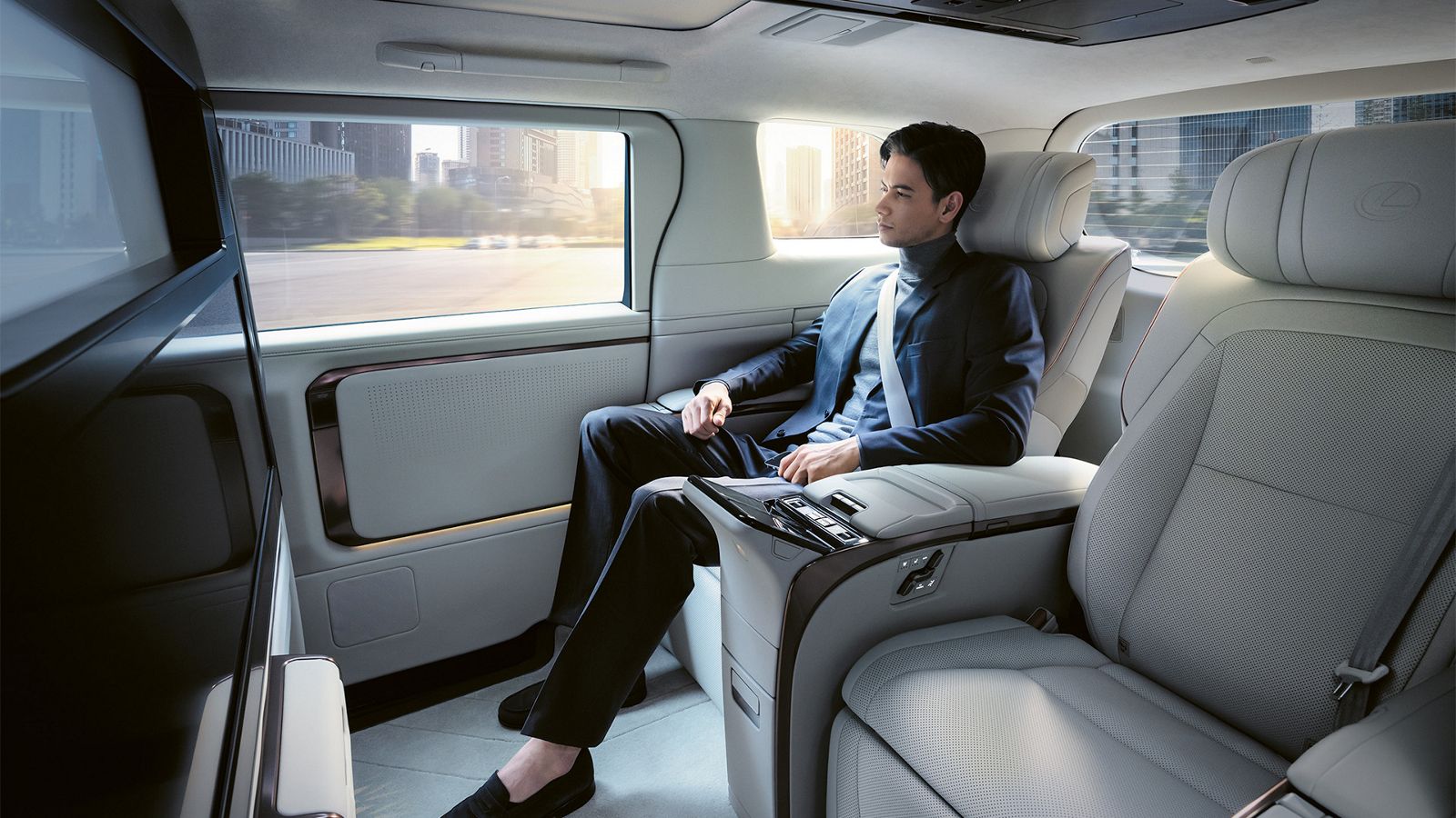 Person sitting in a Lexus LM rear passenger seat